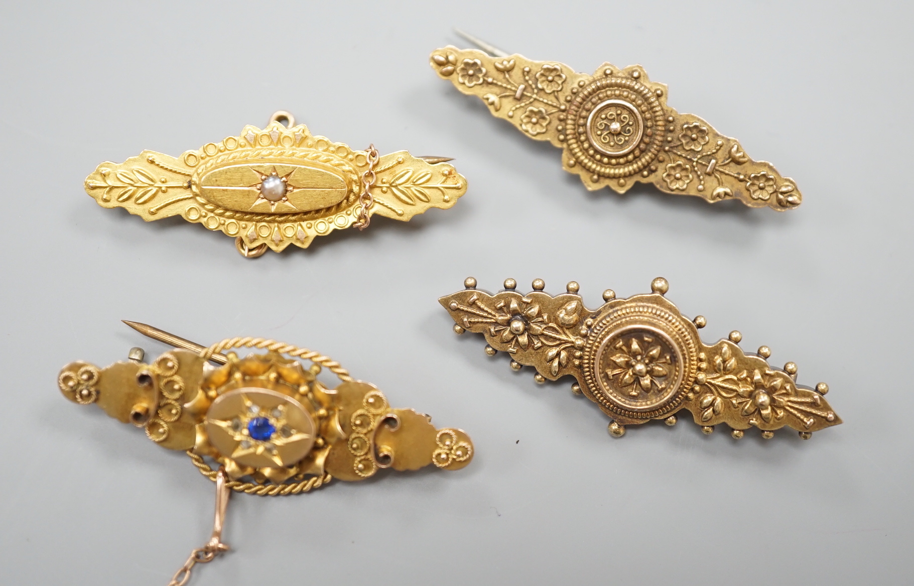 Three early 20th century 15ct brooches including one with seed pearl, 41mm, gross weight 8.1 grams and one 9ct gold brooch, 3.6 grams.